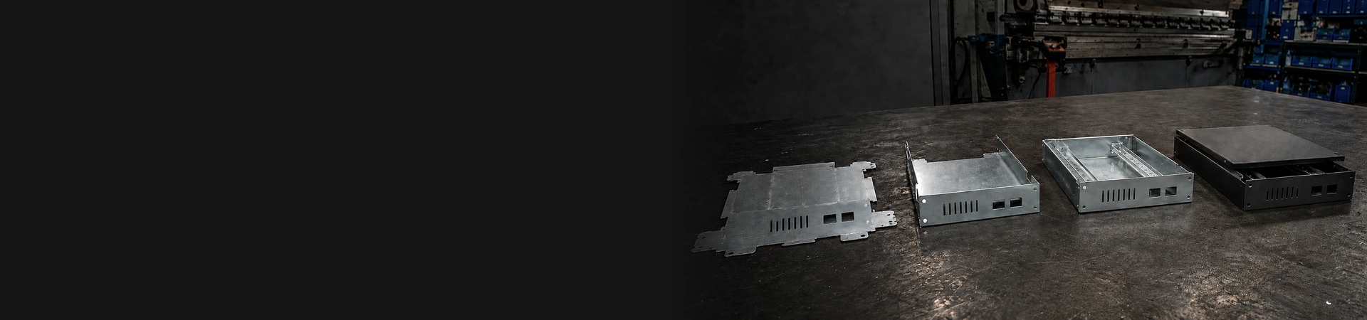 Four manufacturing stages of the same custom sheet metal enclosure from flat blank to powder-coated assembly