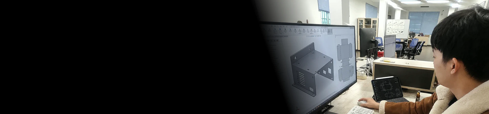 Tongyong engineer reviewing a custom sheet metal enclosure design