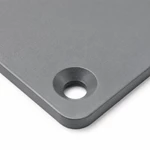 Close-up of countersunk mounting hole and laser-cut edge on gray electrical junction box cover plate