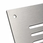 Close-up of round mounting hole and brushed grain on stainless steel ventilation panel