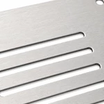 Close-up of laser-cut ventilation slots on brushed stainless steel panel with dark gray cut edges