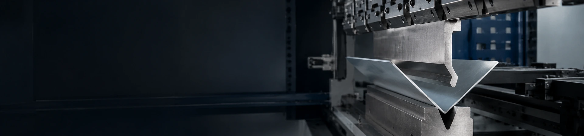 Press brake bending sheet metal between precision upper and lower tooling